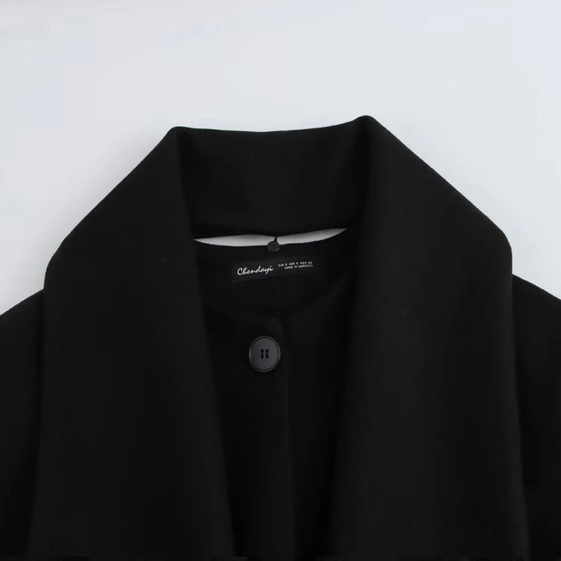 Women's long grey polyester coat with an artificial fur collar and pockets.