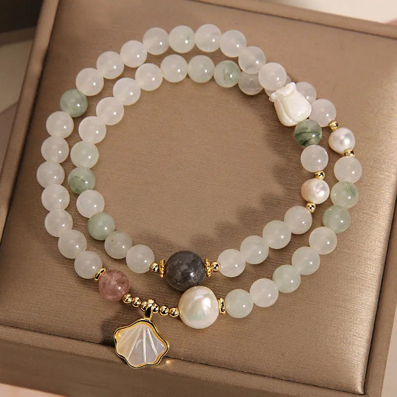 Emerald green crystal bracelet with ginkgo leaf pendant and gold-plated rhinestone details