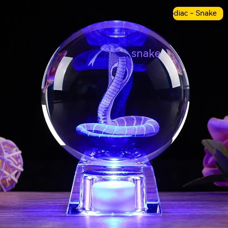 White crystal zodiac ornament with electronic luminous base showing Chinese animal design