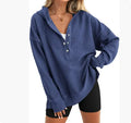 Women's loose fit raglan sleeve sweater in a solid colour, shown in a casual setting.