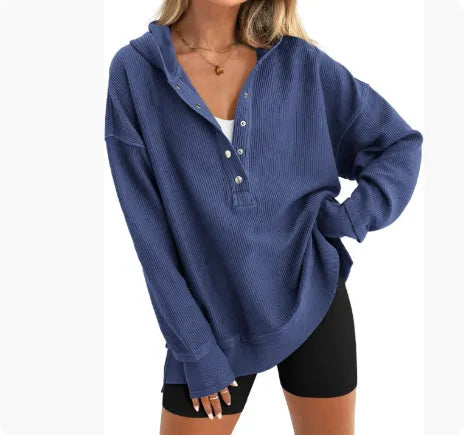 Women's loose fit raglan sleeve sweater in a solid colour, shown in a casual setting.