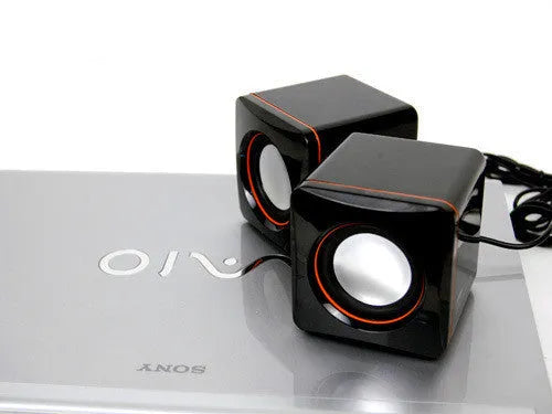 Black square USB-powered 2.0 computer speaker on desktop