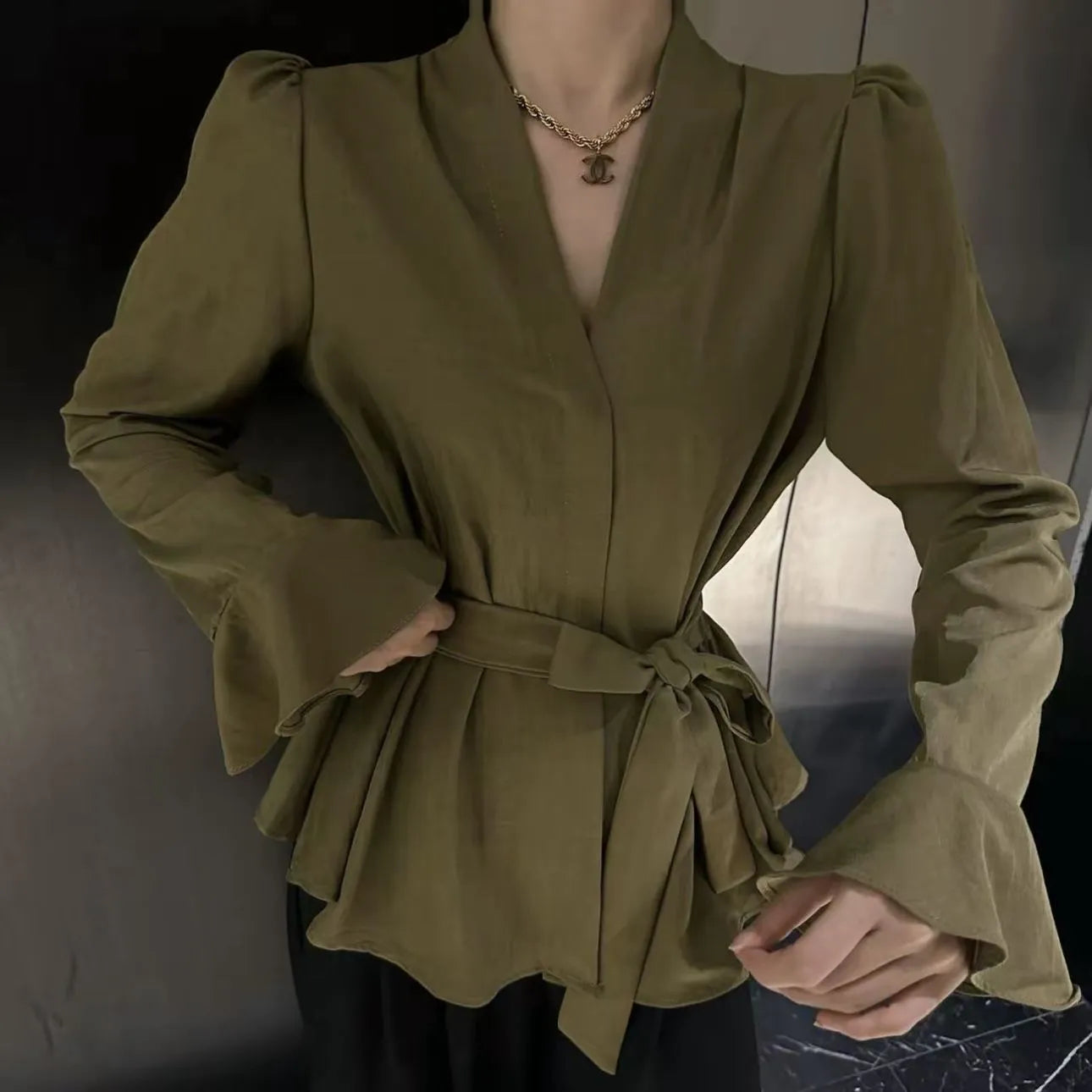 Women's black French-style shirt with irregular collar and long bell sleeves tied at waist