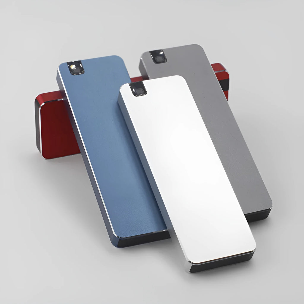 Compact silver portable solid state hard drive with USB cable on a dark surface