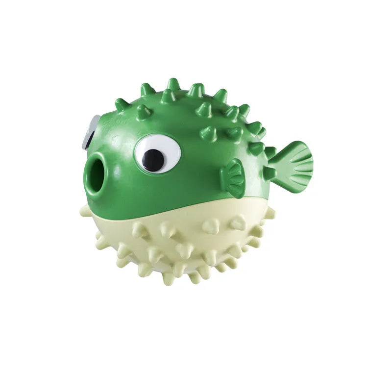 Green fish-shaped dog toy with treat dispensing cavity and raised surface particles