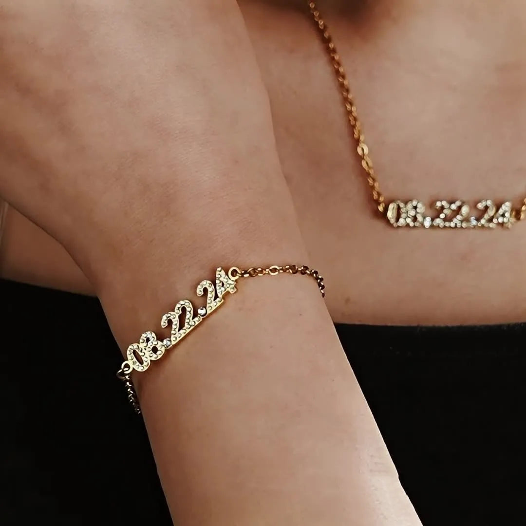 Stainless steel digital bracelet or necklace with diamond-set bezel showing time display, in gold, rose gold, or steel finish.