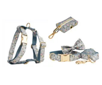 Blue floral patterned dog collar with matching accessories including leash, bow, vest, and poop bag