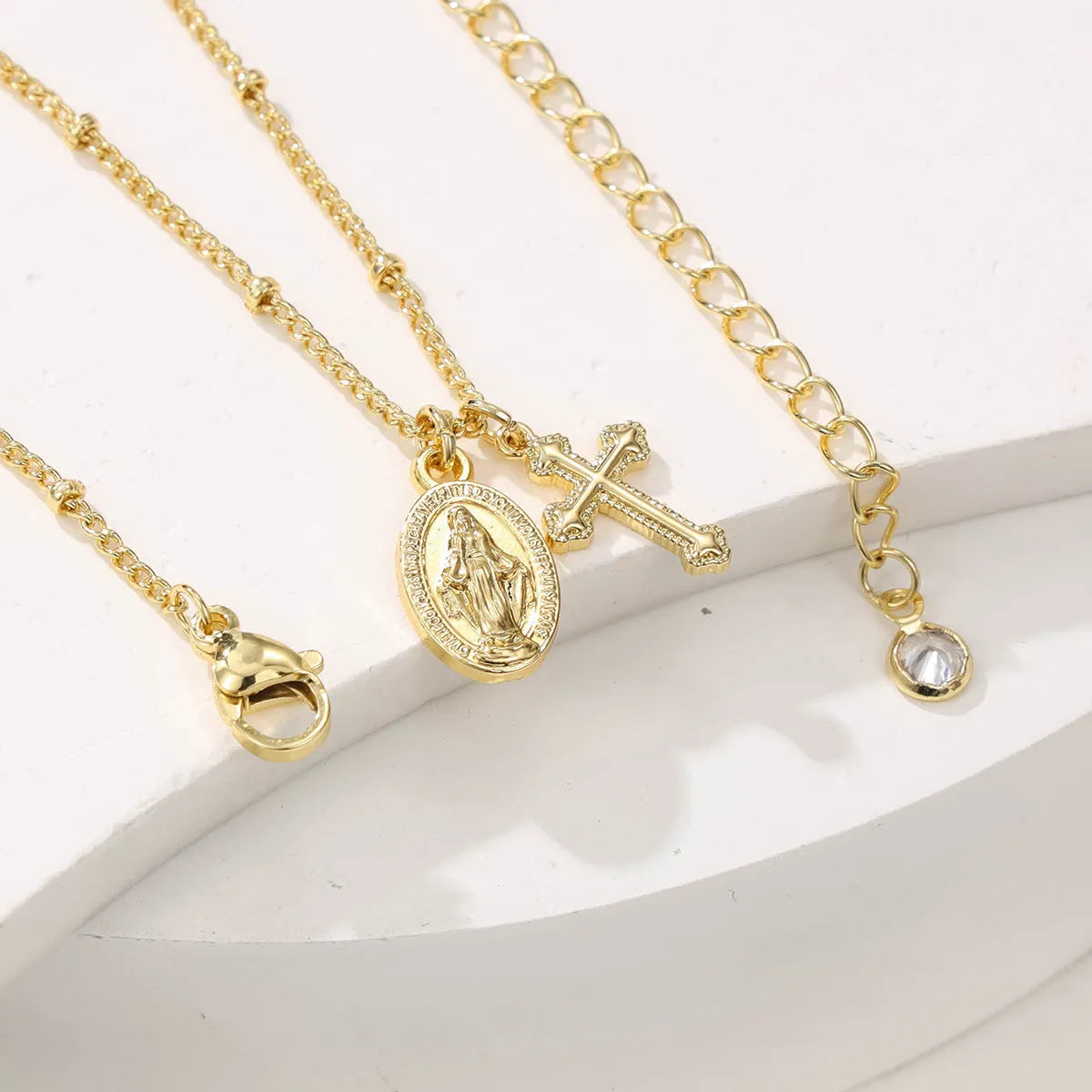 Golden Virgin Mary necklace with geometric cross pendant on copper chain