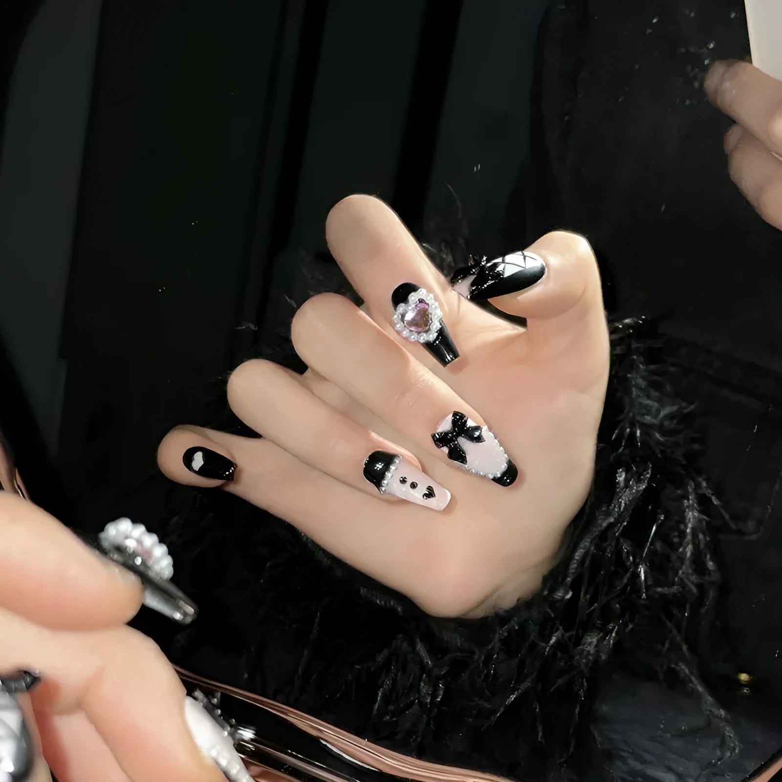 Black detachable manicure set with hand-painted pink hearts and bow patterns in cat eye style