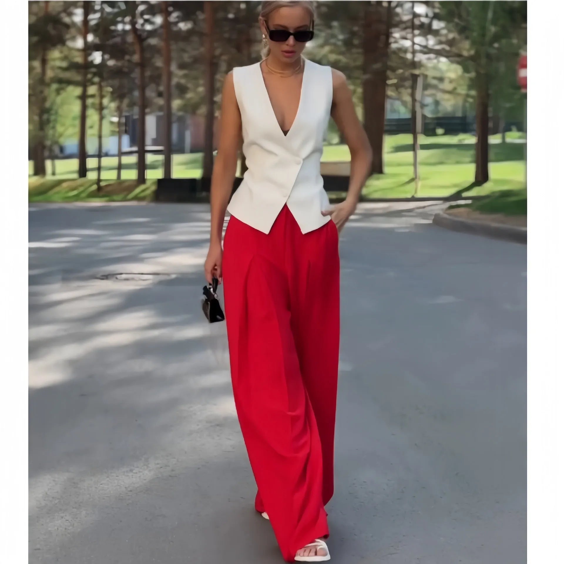 Beige women's sleeveless V-neck top and wide-leg high-waist trousers two-piece set laid flat.