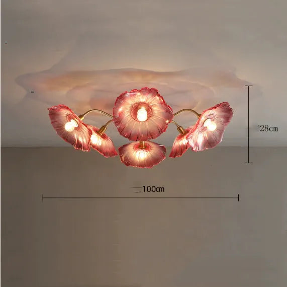 White flower pendant ceiling lamp with five flower heads emitting warm light in modern bedroom