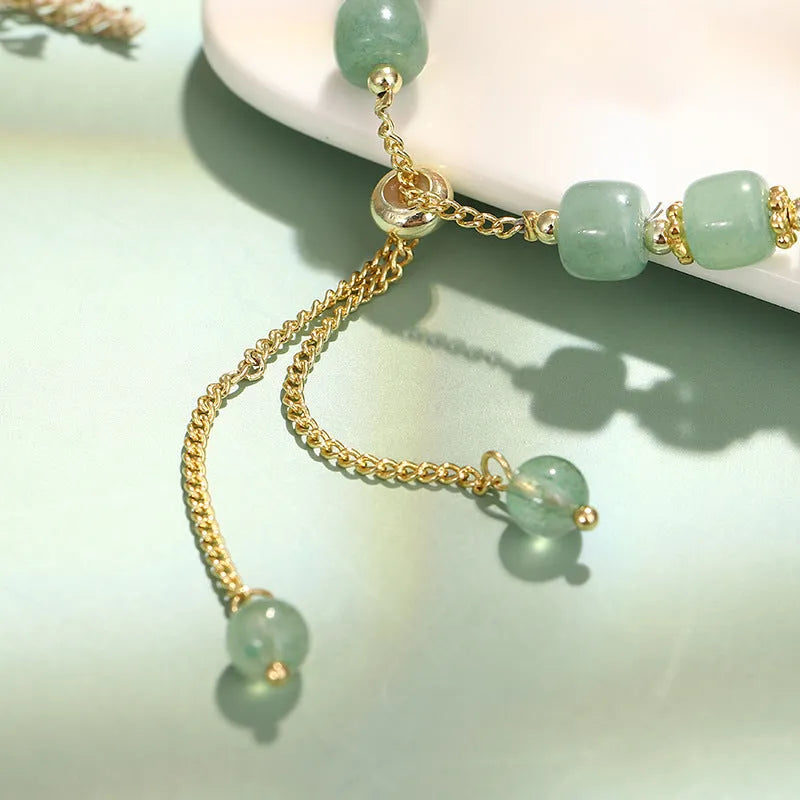 Rabbit motif bracelet with green aventurine and strawberry quartz stones in gold and copper setting