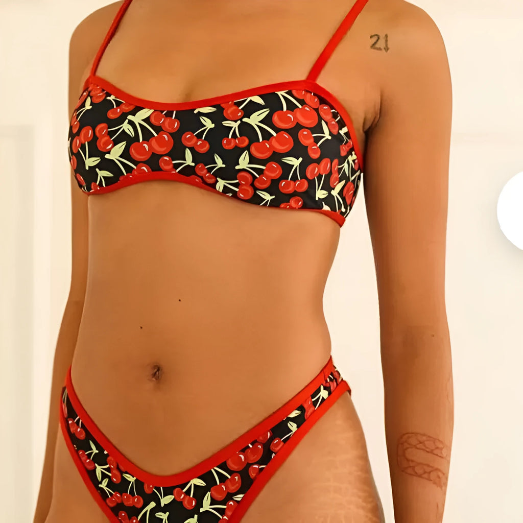 Women's cherry blossom print tube top bikini swimsuit set on a neutral background.