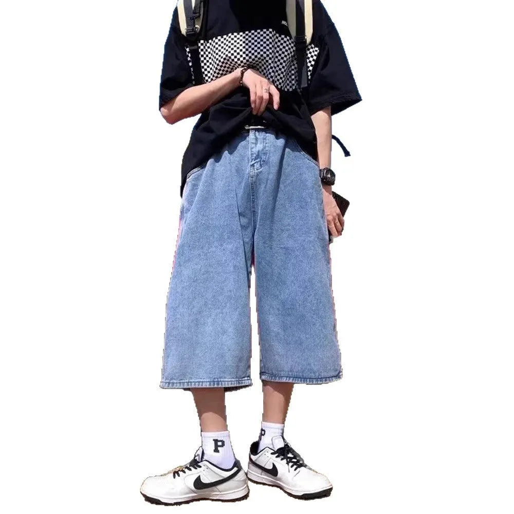 Man wearing blue washed denim pirate shorts with a cropped length and high waist.