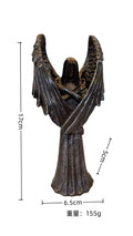 Dark coloured resin angel statue ornament with dimensions 6.5 cm by 5 cm by 17 cm.