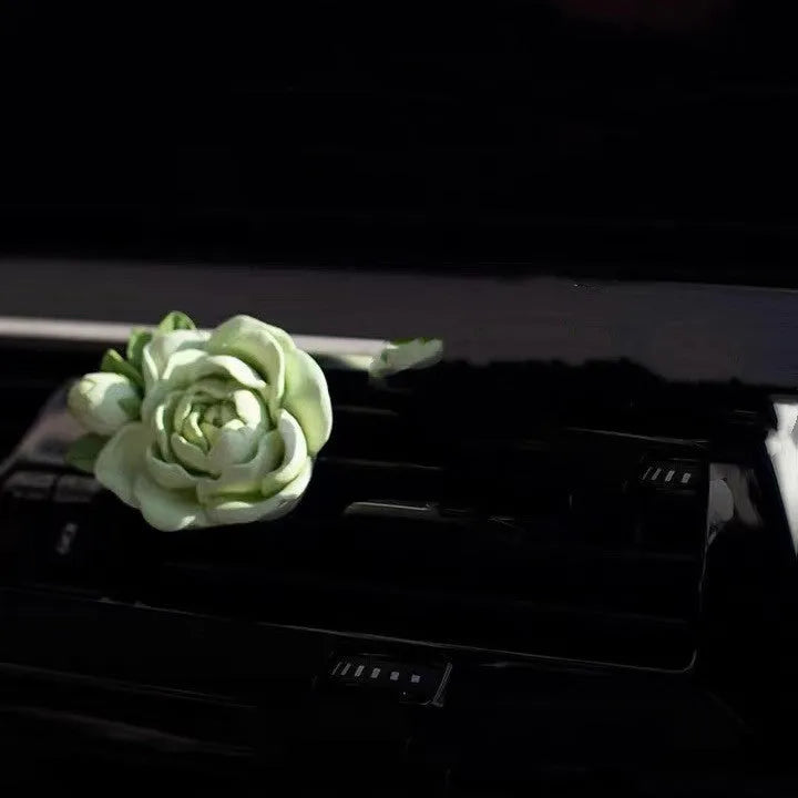 Jasmine-scented car air freshener with gypsum base clipped to vehicle vent
