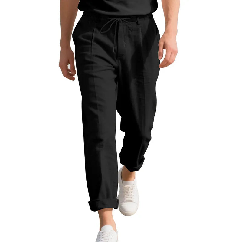 Men's loose-fit linen trousers in light khaki colour with a drawstring waistband.