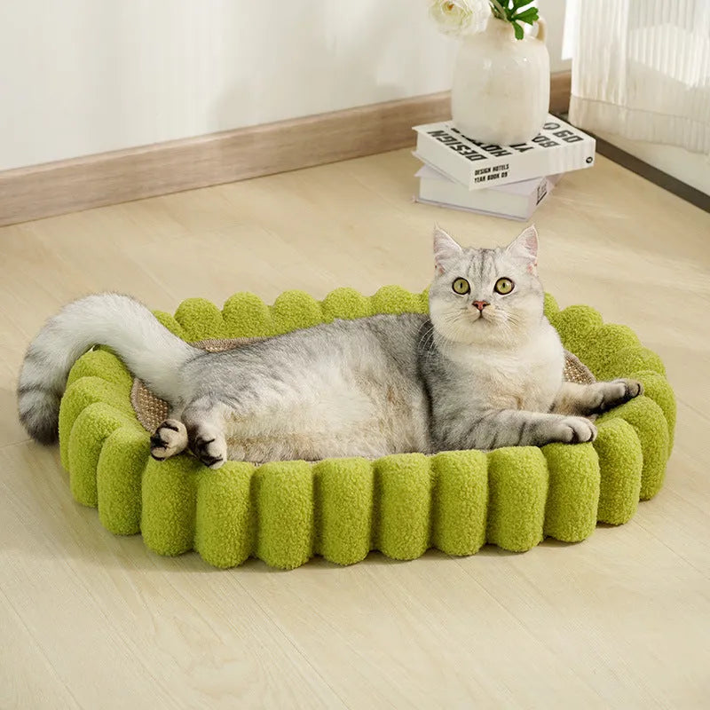 Green oval-shaped cat scratcher pad with sisal surface serving as a scratching area and cat bed.