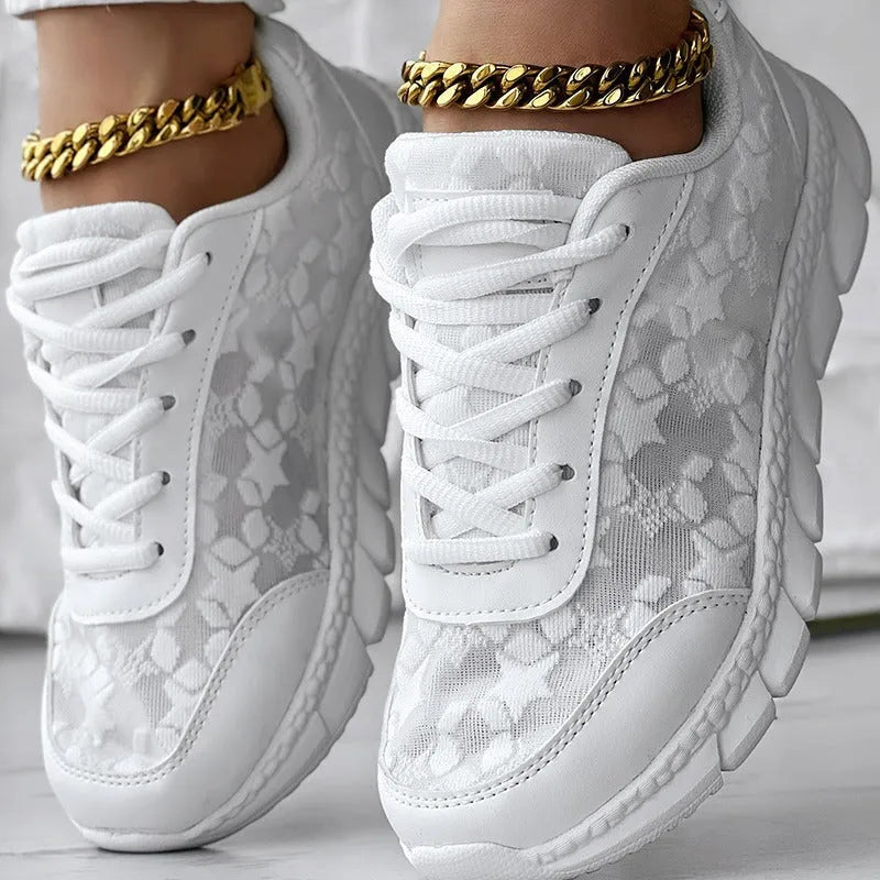Women's white canvas casual sports shoes with soft bottom and flat heel on a light background.
