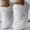 Women's white canvas casual sports shoes with soft bottom and flat heel on a light background.