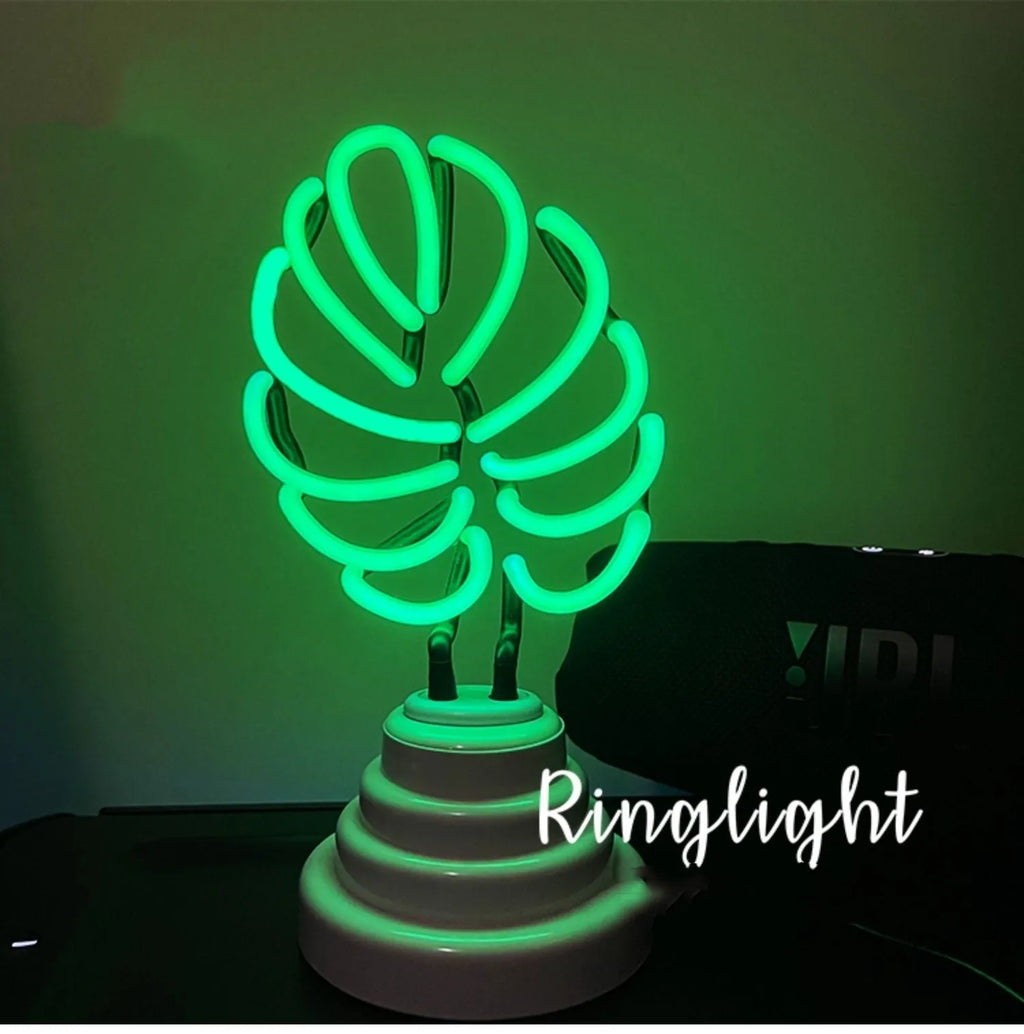 White minimalist bamboo-shaped desk lamp with green glow, showing USB cable and two size options.