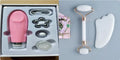 White jade double-headed facial roller and gua sha scraping board set on a plain background.