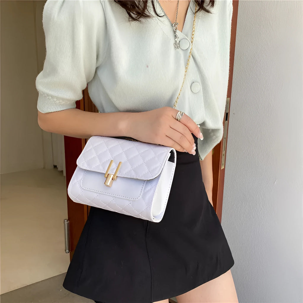 Women's solid colour crossbody bag with diamond lattice chain strap in black, shown from the front.