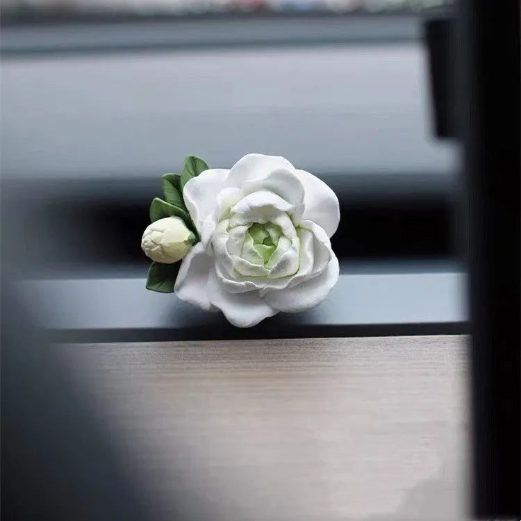 Jasmine-scented car air freshener with gypsum base clipped to vehicle vent