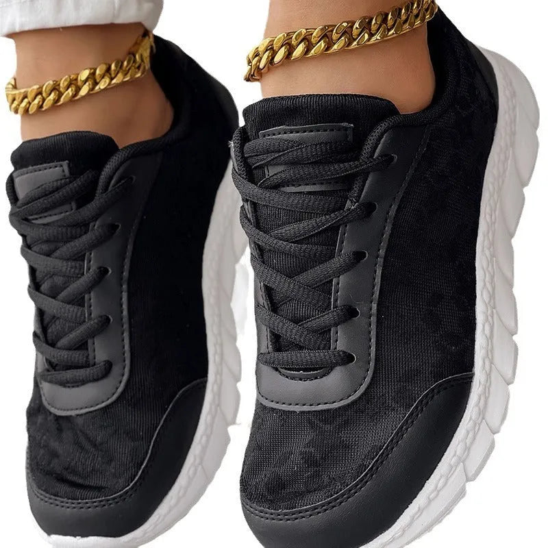 Women's white canvas casual sports shoes with soft bottom and flat heel on a light background.