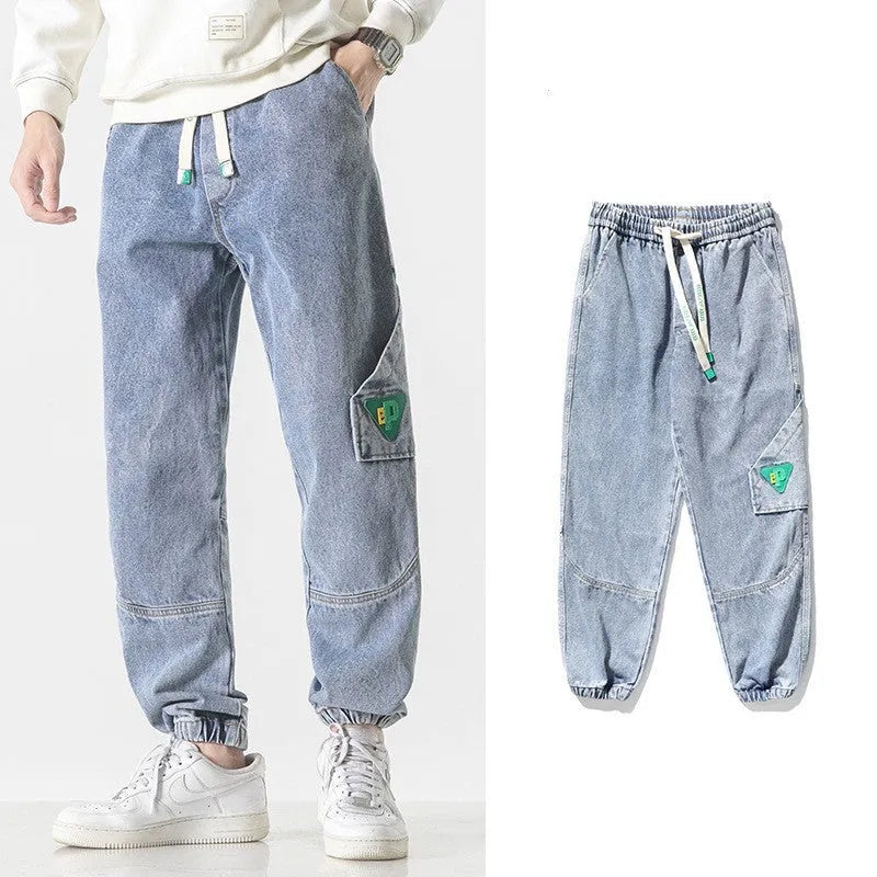 Men's loose-fit tapered cotton trousers in black, shown on a model