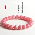 Women's geometric crystal bracelet with longevity lock in natural red rhodochrosite patterns showing angular bead shapes