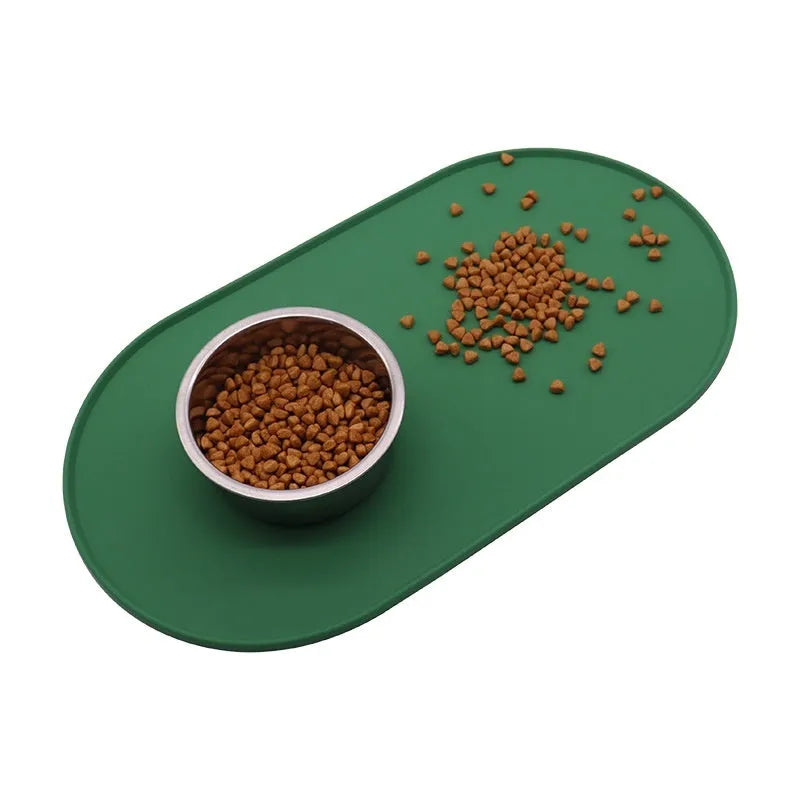 Silicone waterproof cat feeding placemat with non-slip base in beige colour on a wooden floor.