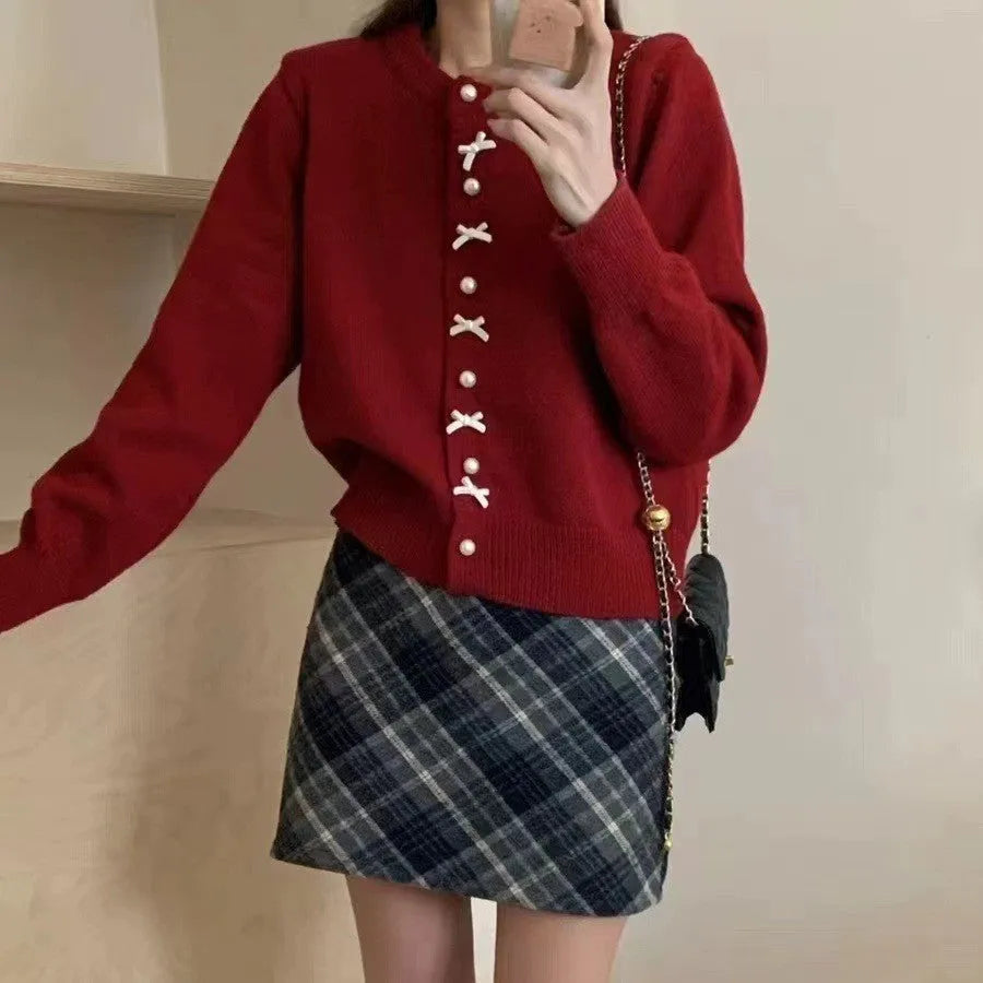 Women's solid colour cardigan with pearl buttons and bow pattern detail on cashmere-style fabric