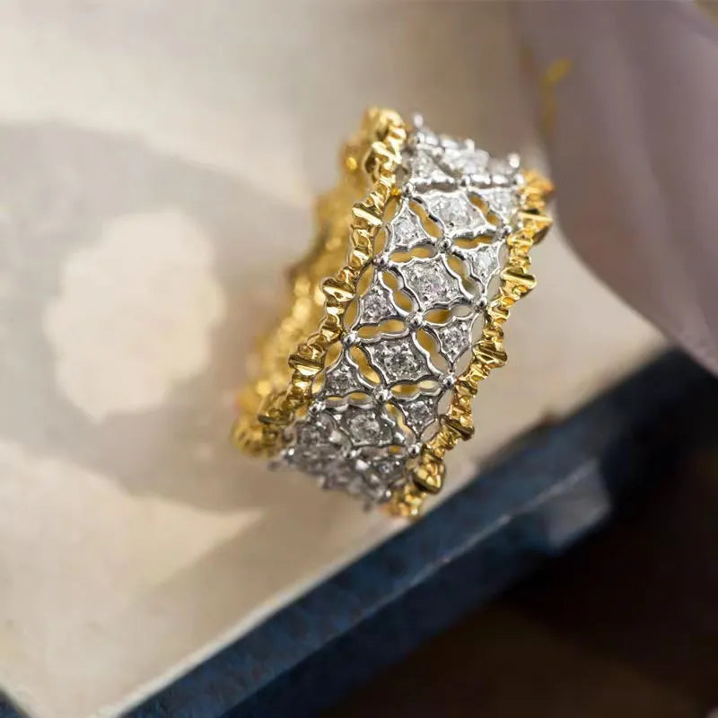 Geometric two-tone zircon ring in gold and silver on copper, showing round stone and available in sizes 6-10.