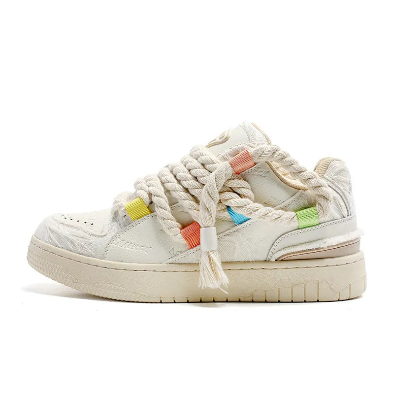 Creamy white old damage lace-up retro skateboard shoes with low-top round toe and platform sole.