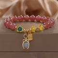 Red women's bracelet with strawberry quartz beads, alloy metal, and rhinestone detailing