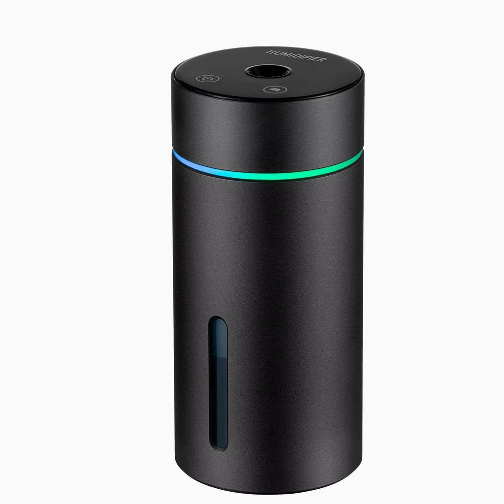 Black aluminium car humidifier and essential oil diffuser with night light on a desk.