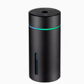 Black aluminium car humidifier and essential oil diffuser with night light on a desk.