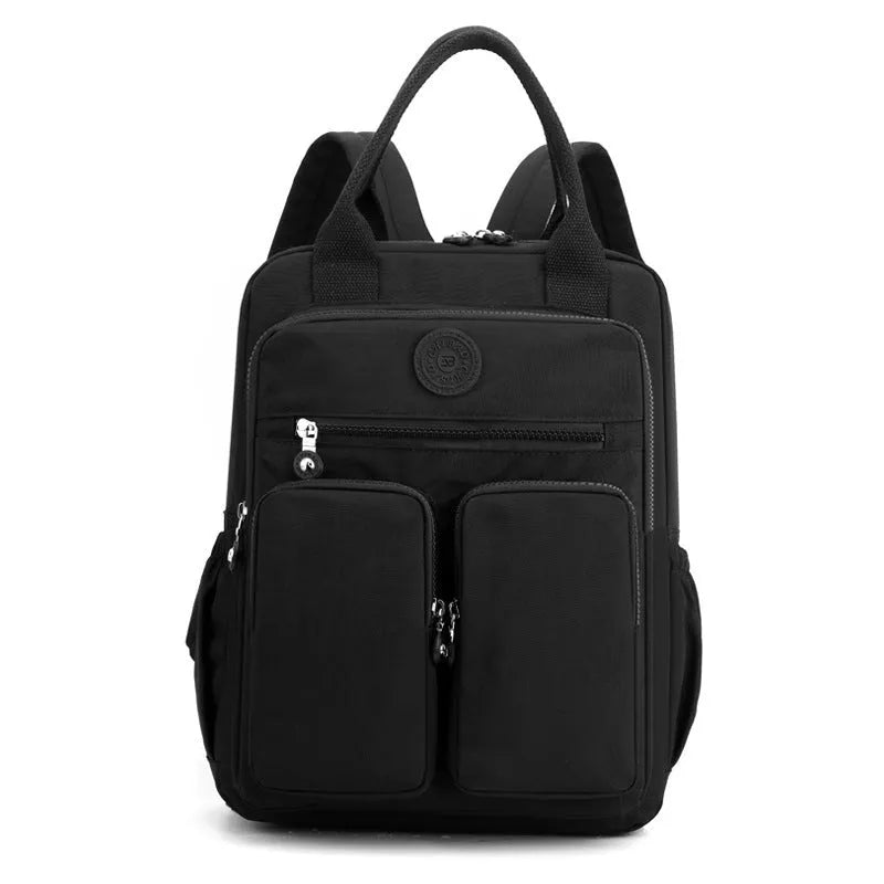 Waterproof nylon women's backpack in grey showing front pockets and internal laptop compartment.