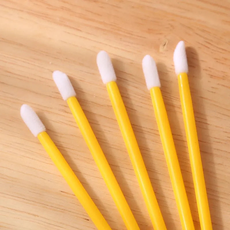 Disposable lip brushes with flocked tips and black handles in multiple colours
