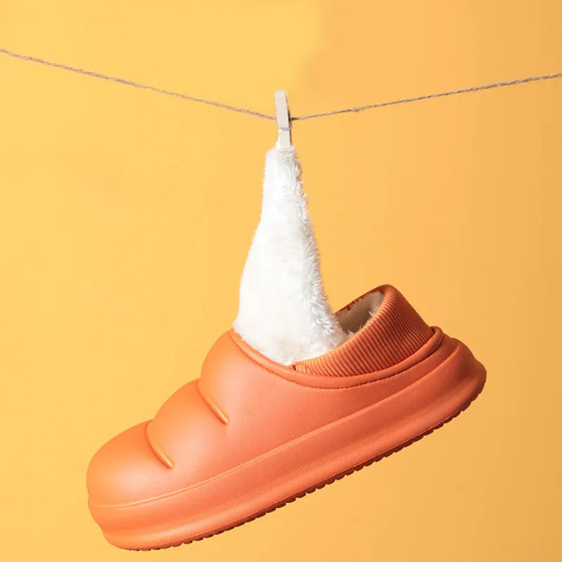 A pair of waterproof EVA couple slippers with a plush lining, shown in a choice of colours like green, pink, or grey.