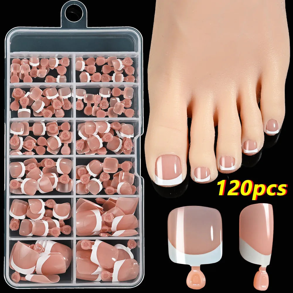 120 piece box of square short French style artificial toe nails with white tips on nude base.