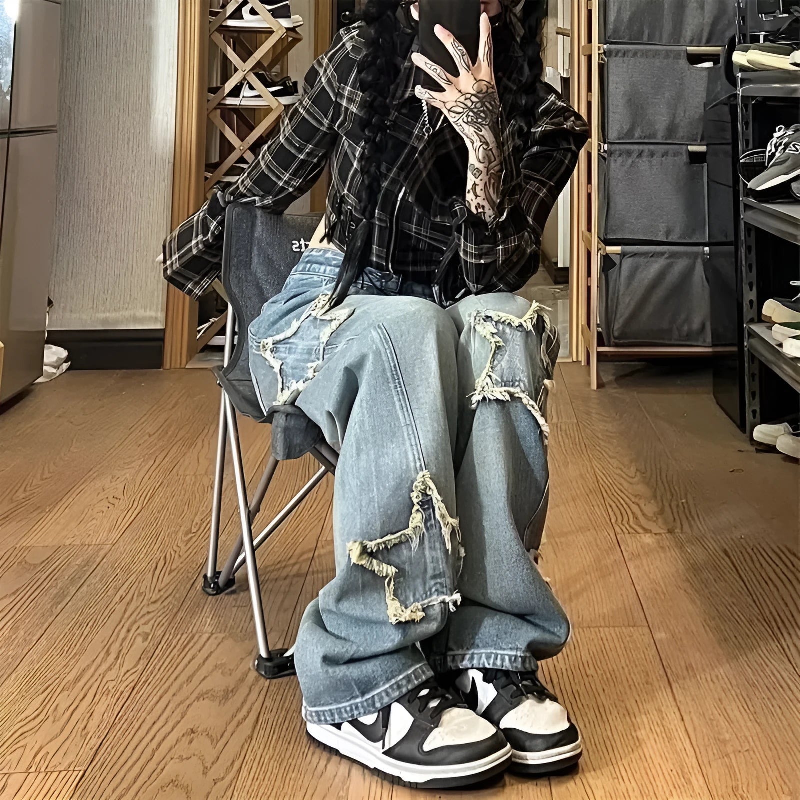 Blue women's high waist wide-leg denim jeans on a hanger, showing straight leg cut.