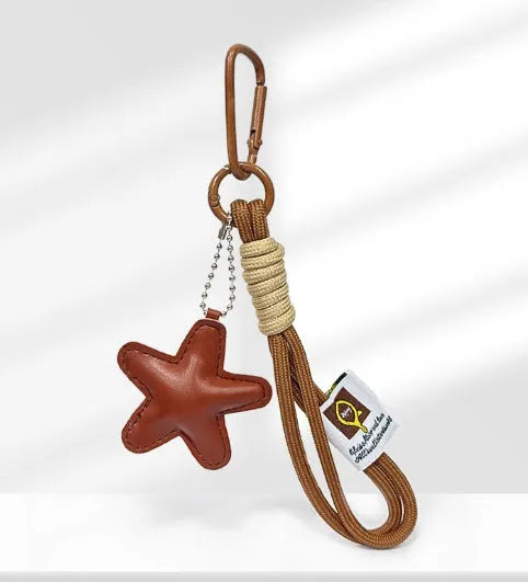 Handmade soda bread style handbag pendant with brown strap showing cartoon baked goods design