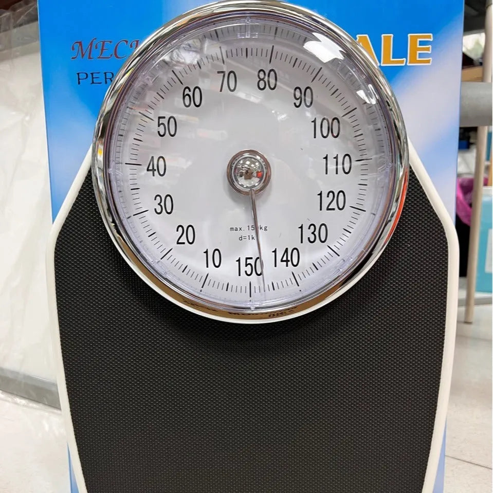 Black mechanical body weight scale with large dial display measuring 47x35x11cm