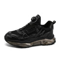 Men's black casual sneakers with rotating button closure and mesh upper on rubber sole.