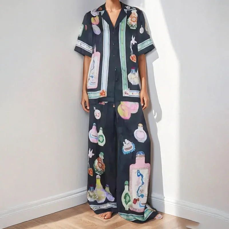 Women's black casual matching set with cartoon animation print, featuring a cardigan sleeve top and trousers