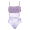 Purple hollow polyester swimsuit and matching wrap skirt set on mannequin