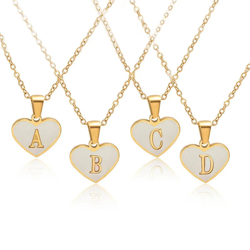 Gold-plated stainless steel necklace with a letter pendant and heart charm on a 45+5cm chain.