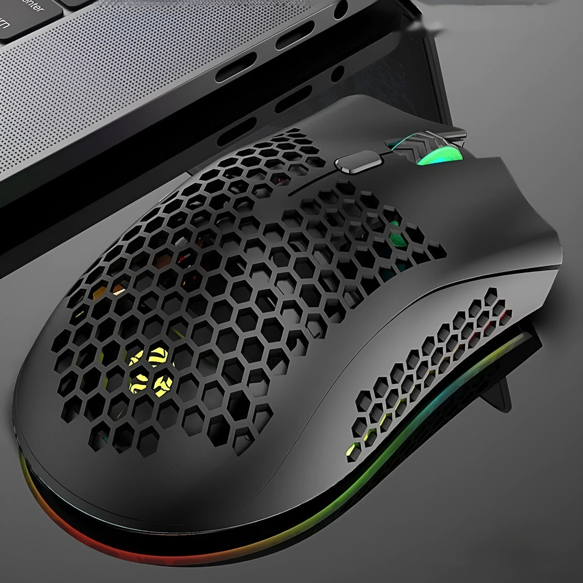 BM600 wireless gaming mouse with luminous charging in cyan, black, or white on a desk.